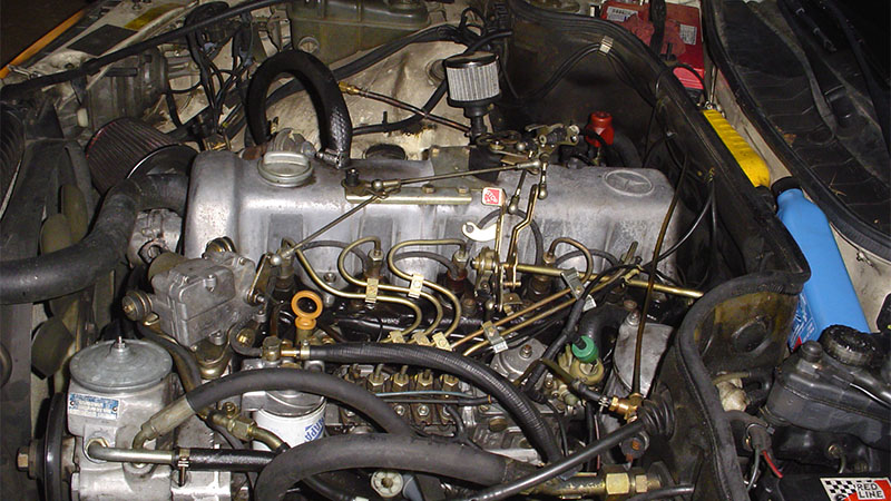 Close-up of a Mercedes OM617 engine under the hood of a 300 SD.