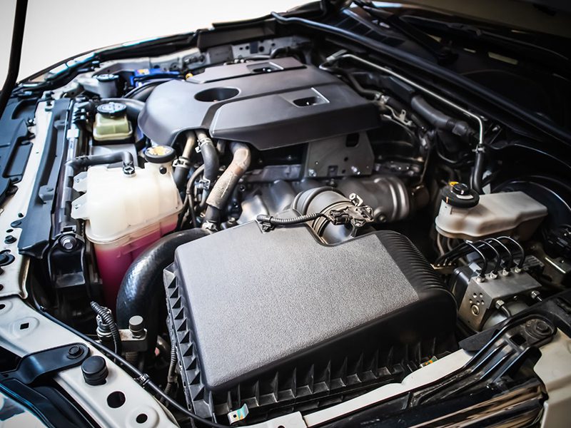Close-up view of a 2.8L turbo diesel engine under the hood of a Toyota Fortuner, showcasing clean engine layout and components.