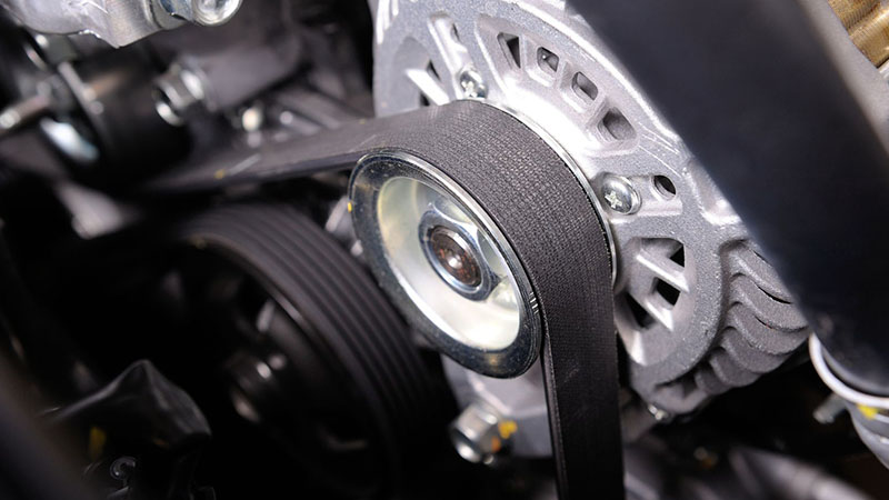 Close-up of timing belt during engine installation.