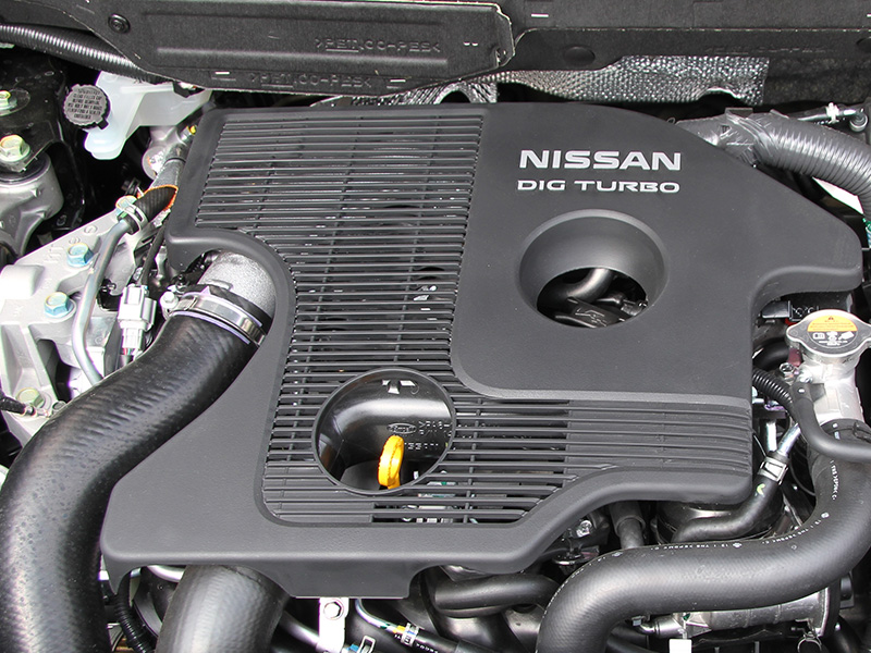 Nissan DIG turbo engine under the hood of a compact car.
