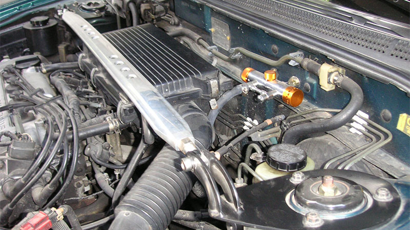Close-up view of a Nissan Sentra engine bay with the hood lifted.