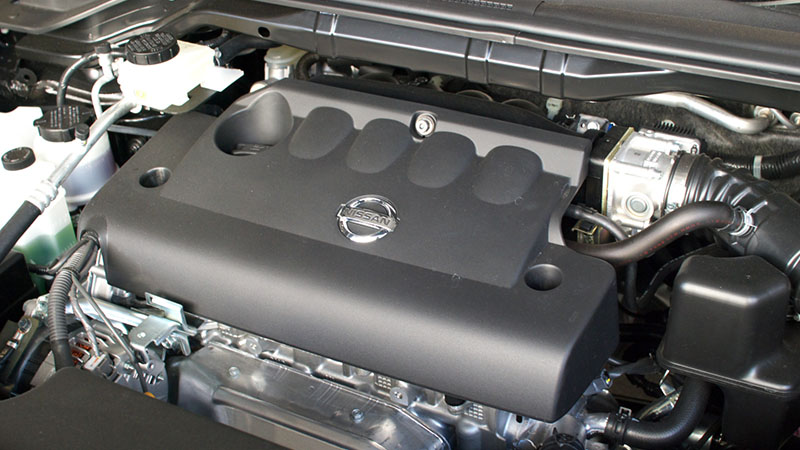 Close-up of Nissan QR25DE engine under the hood.