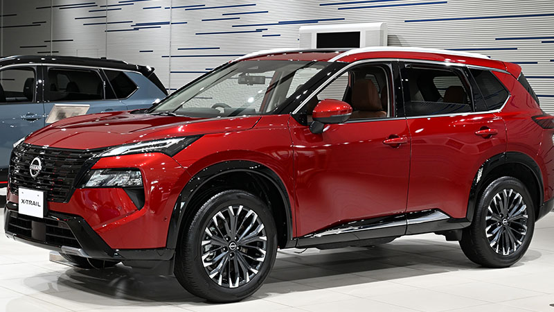 Red 2025 Nissan X-Trail e-4ORCE close-up.