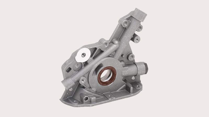 Close-up view of an engine oil pump highlighting its structure and connection points.