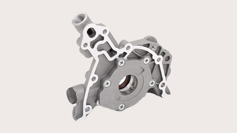 Close-up view of an engine oil pump showing its mechanical components and design details.