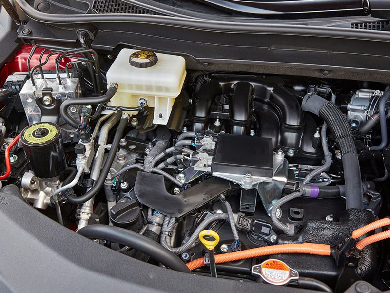Close-up view of a car engine bay showing detailed engine components.