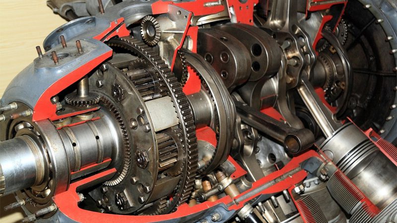 Close-up view of an engine, highlighting piston locations within the cylinder block.