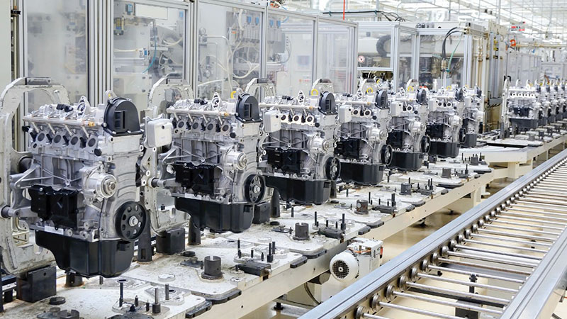 Automotive engine assembly line in a modern manufacturing facility.