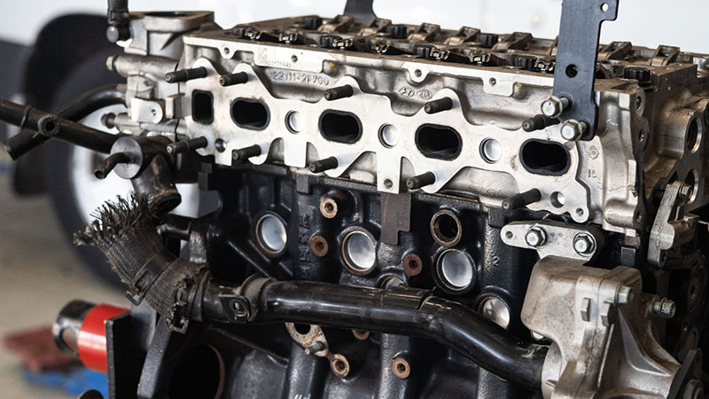 Replacement engine at an auto repair shop ready for installation.