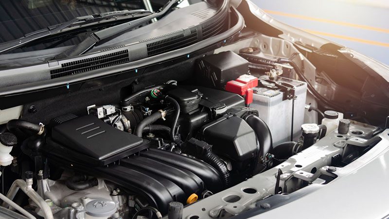 Detailed view of a modern car engine with visible components, wiring, and clean metallic finishes.