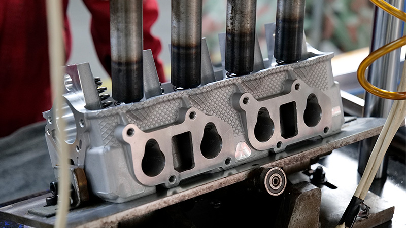 Cylinder head assembly at Woda Auto manufacturing facility.