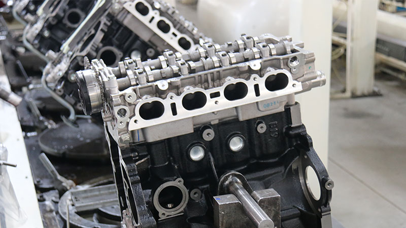 Close-up of a bare engine on the factory assembly line.