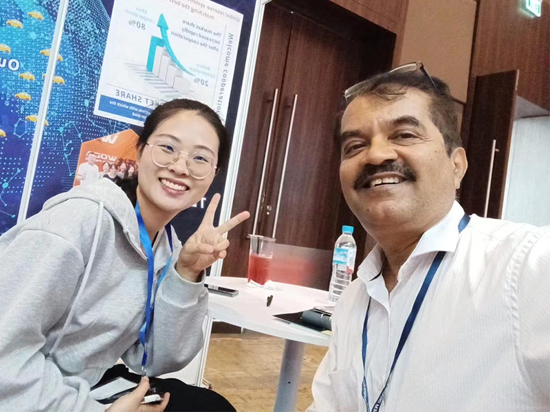 Woda team members smiling with a customer at an industry exhibition