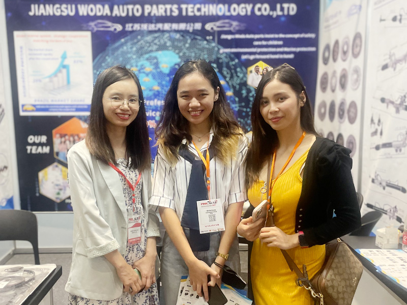 Woda sales manager with customers at an auto parts exhibition