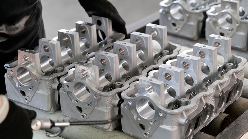 Close-up of newly manufactured cylinder heads arranged in an automotive factory.