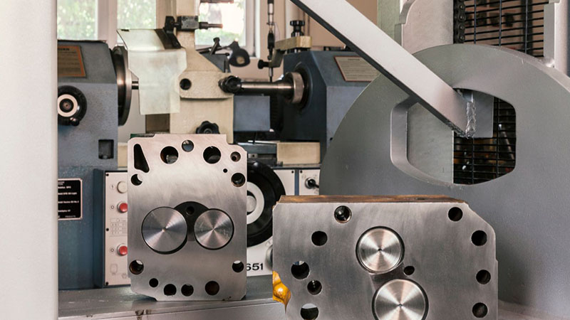 Close-up of cylinder heads on a manufacturing machine.