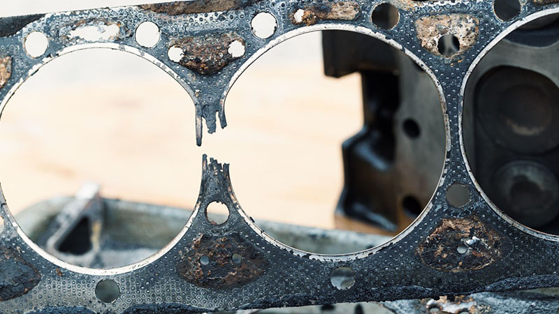 Close-up of blown cylinder head gasket.