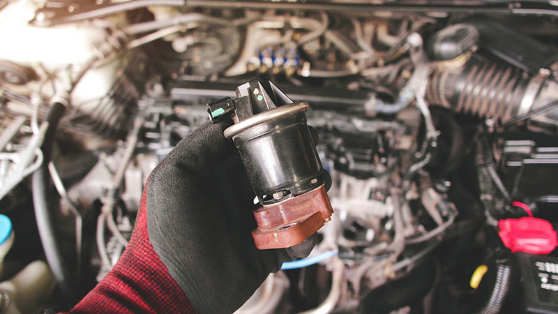 Close-up of EGR valve in a diesel engine during auto repair.