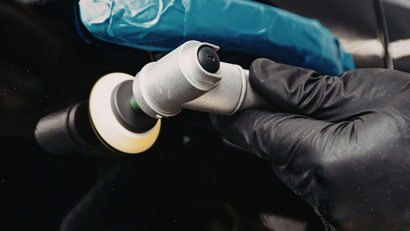 Mechanic installing a fuel injector in a diesel engine.