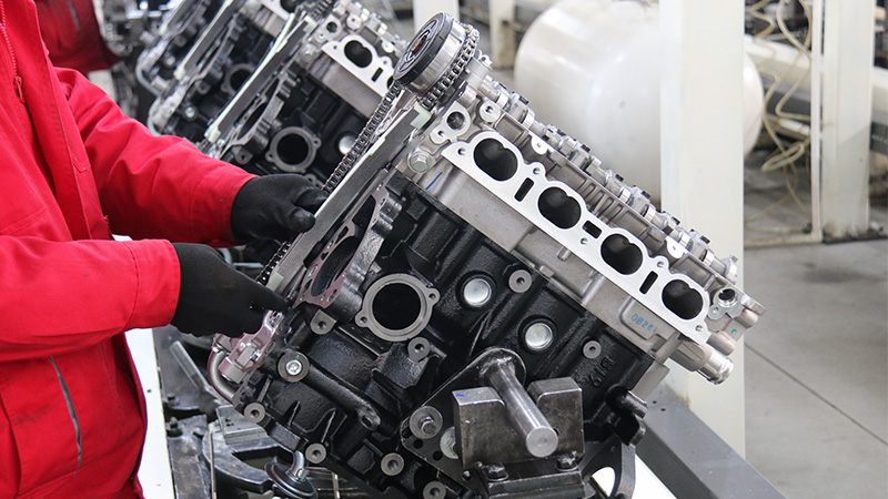 Automotive engine assembly line inside Woda Auto manufacturing facility.