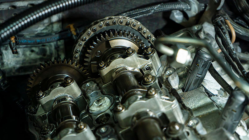 Close-up of timing chains inside a modern car engine.