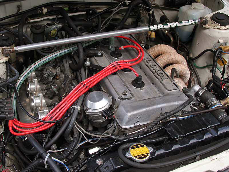 Engine bay of a classic Toyota Corolla Sedan GT TE71 showing the original Toyota engine setup and components.