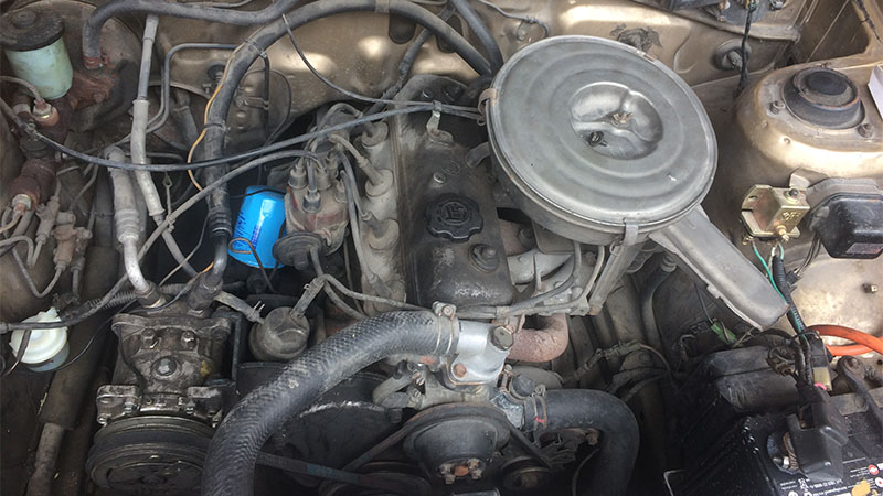 Toyota 4K engine installed in a Toyota Corolla DX KE70 with visible classic engine bay components.