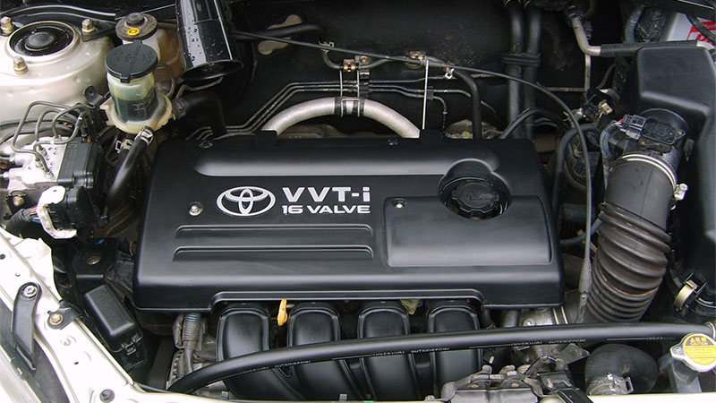 Close-up view of a Toyota 1ZZ-FE engine showing engine cover and internal components.