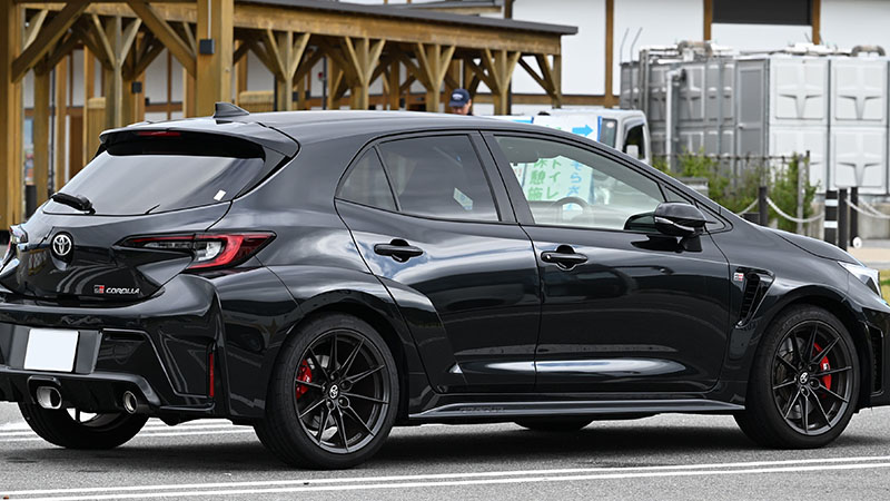 Rear view of a Toyota GR Corolla RZ performance hatchback parked outdoors.