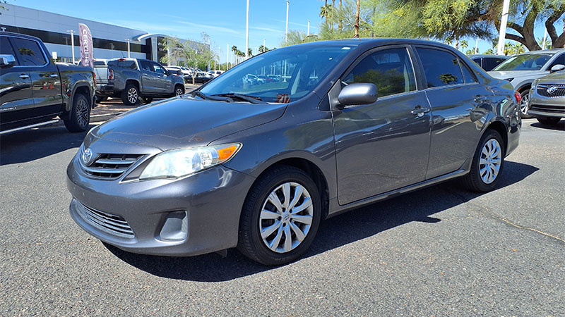 Close-up of a Toyota Corolla LE showing front grille, headlights, and exterior body details.