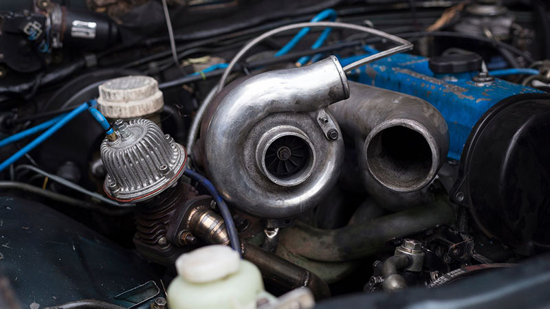 Turbocharger mounted on a car engine.