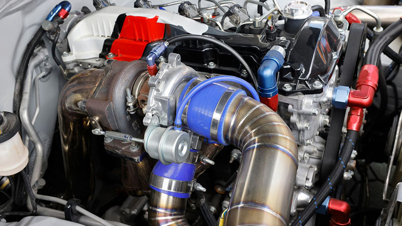 Turbocharger mounted on a car engine.