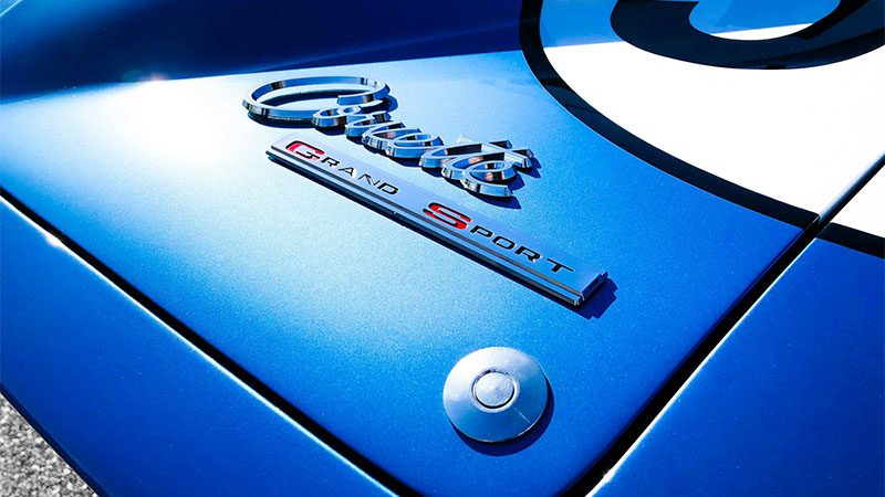 A close up of the emblem on a blue sports car.