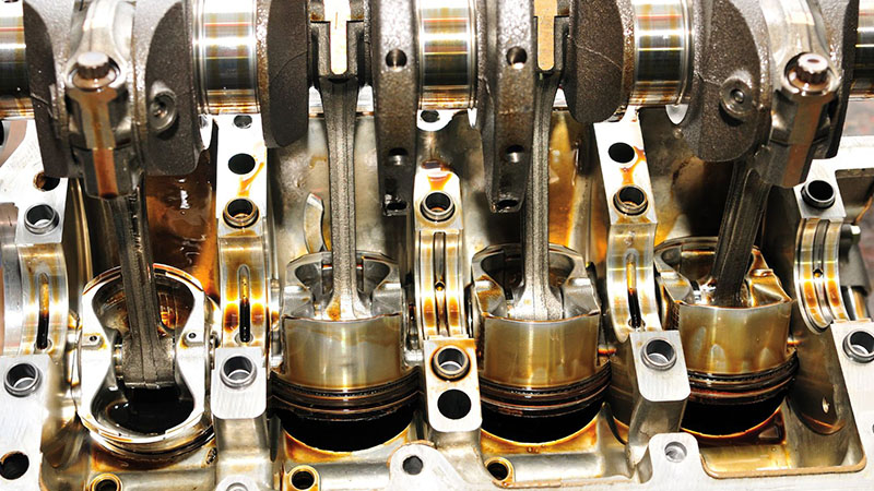 Internal view of an engine showing the crankshaft and pistons in motion.