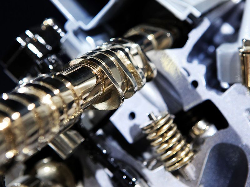 Camshaft and valves operating in a Variable Valve Timing (VVT) system to optimize engine performance and efficiency.