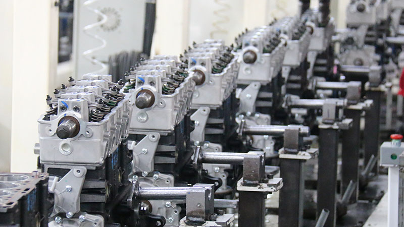 Automotive engine assembly line at Woda Auto factory showing engine production processes.