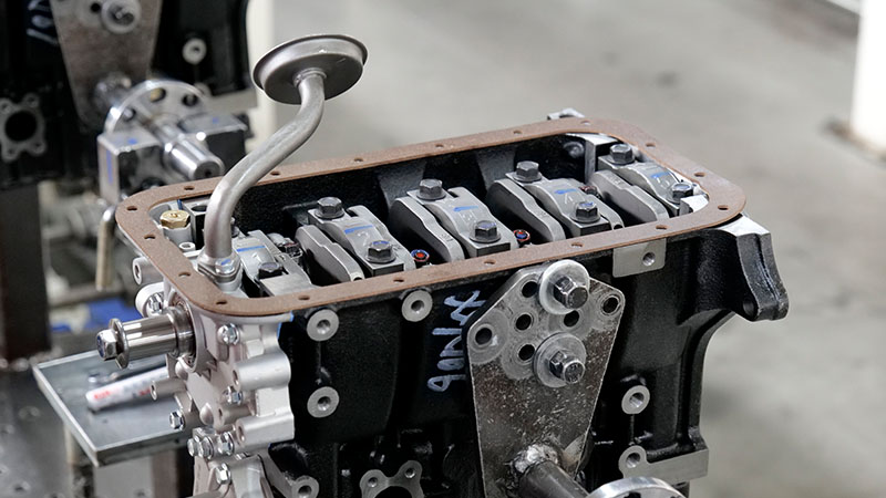 Close-up view of automotive engines being assembled at an engine supplier factory.
