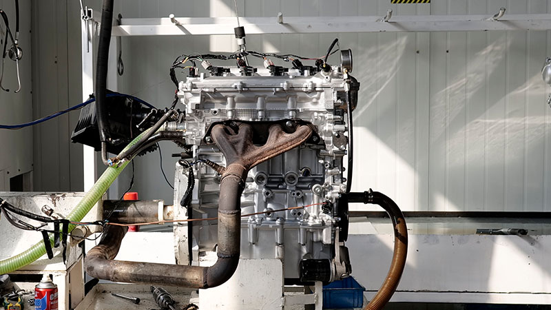 Assembled engine on a hot running test bench at an engine manufacturing facility.