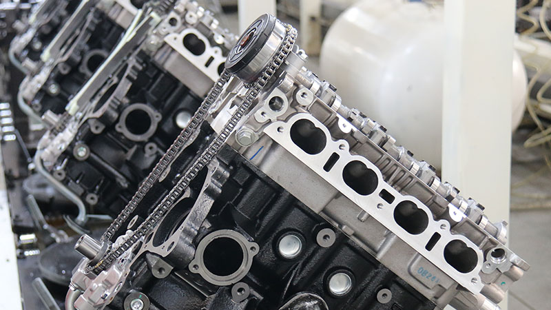Close-up view of assembled automotive engines on a factory production line.