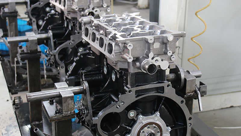 Close-up of engine assemblies during automotive manufacturing at a factory production line.