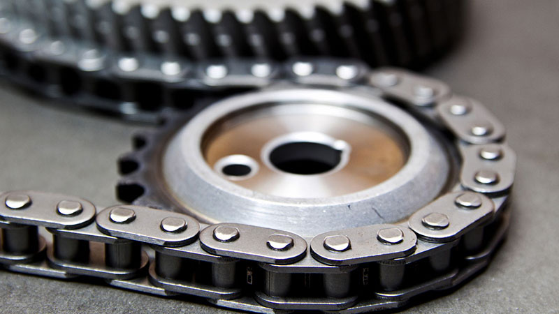 Close-up of engine timing chain and sprocket components.